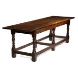A CHARLES II OAK REFECTORY TABLE PROBABLY WELSH, C.1680 the boarded top with cleated ends, above a