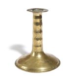 A BRASS TRUMPET CANDLESTICK C.1650-80 the plain collar above a ribbed or corded stem and slightly