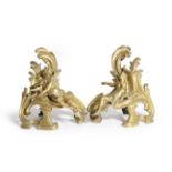 A PAIR OF FRENCH ORMOLU CHENETS IN LOUIS XV SIDE modelled as a man with a hammer and anvil and a