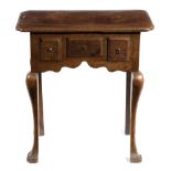 A SMALL GEORGE II OAK LOWBOY C.1740-50 the top with feather banding and re-entrant corners above