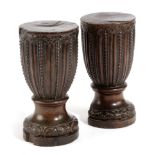 A PAIR OF EARLY GEORGE III MAHOGANY SOLID URNS C.1760-70 with floret and bead decoration, possibly