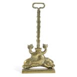 A VICTORIAN BRASS DOORSTOP LATE 19TH CENTURY with a pair of dolphins beneath a foliate handle 47cm