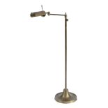 A BRASS ADJUSTABLE FLOOR LAMP MODERN with a rotating shade on a folding arm and telescopic stem,