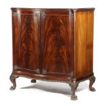 A PAIR OF EDWARDIAN MAHOGANY SERPENTINE SIDE CABINETS IN GEORGE II STYLE BY HOWARD & SONS, EARLY