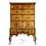 A WALNUT CHEST ON STAND EARLY 18TH CENTURY AND LATER with two short and three long crossbanded