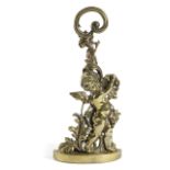 A BRASS BACCHANALIAN CHERUB DOORSTOP BY PEERAGE, EARLY 20TH CENTURY the leaf scroll handle above a