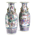 A PAIR OF CHINESE PORCELAIN FAMILLE ROSE VASES 19TH CENTURY painted with panels of warriors to one