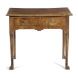 A GEORGE II WALNUT LOWBOY C.1730 with a quarter veneered and crossbanded top, above a pair of frieze