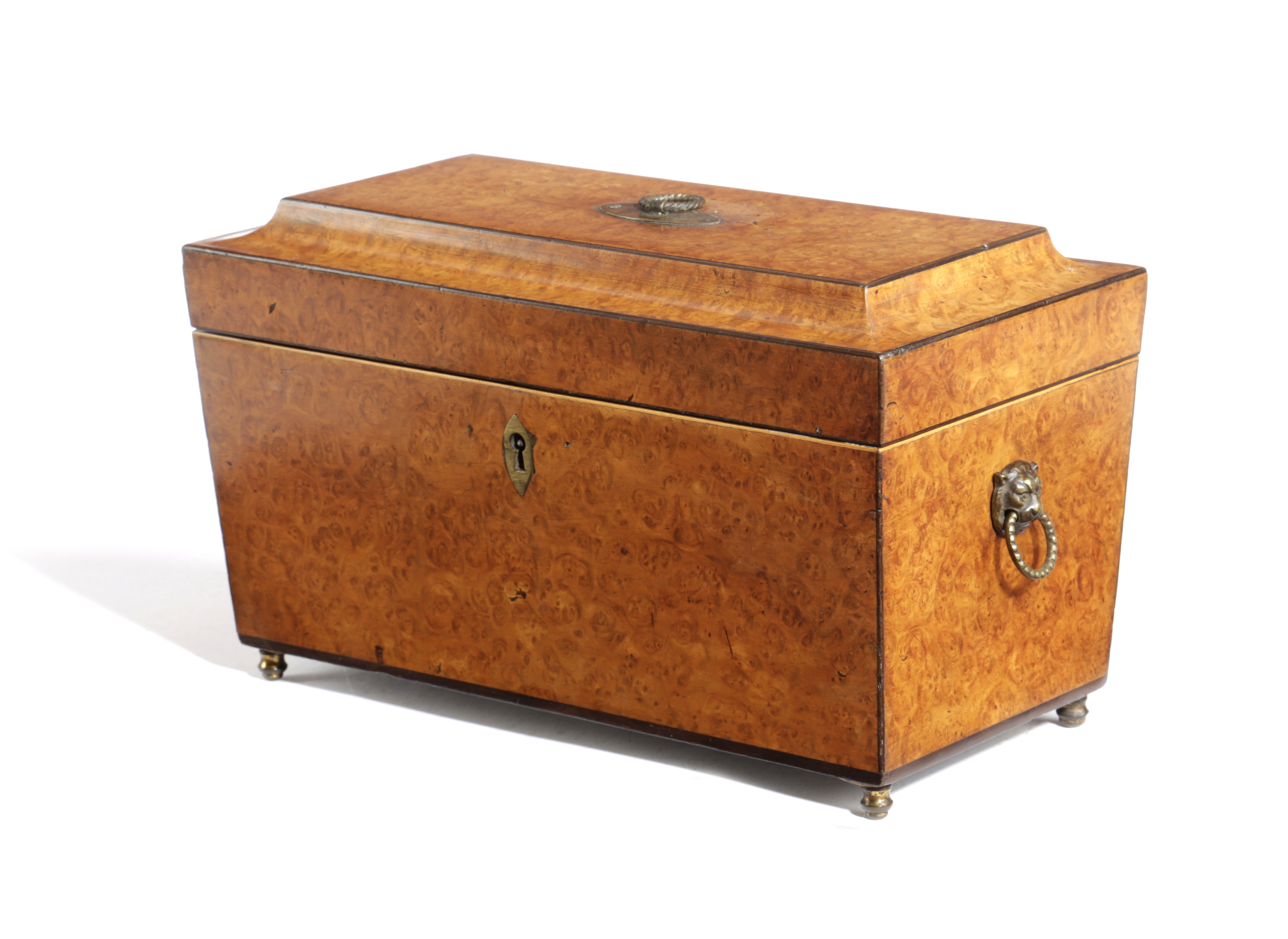 `A GEORGE IV AMBOYNA TEA CHEST EARLY 19TH CENTURY of sarcophagus form, with a pair of canisters with