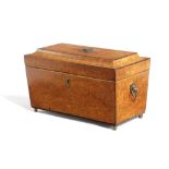 `A GEORGE IV AMBOYNA TEA CHEST EARLY 19TH CENTURY of sarcophagus form, with a pair of canisters with