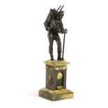A FRENCH BRONZE FIGURE OF A PEDLAR LATE 18TH / EARLY 19TH CENTURY modelled as a young man with a