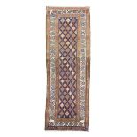 A NORTH WEST PERSIAN RUNNER C.1910 the indigo field with a diamond lattice design, enclosed by ivory