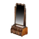 A GEORGE I WALNUT DRESSING TABLE MIRROR EARLY 18TH CENTURY the arched plate in a gilt, moulded slip,