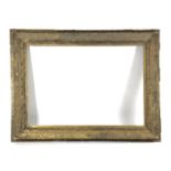 A LARGE VICTORIAN GILT COMPOSITION PICTURE FRAME C.1870 the inner slip decorated with swags of