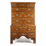 A WALNUT CHEST ON STAND EARLY 18TH CENTURY AND LATER with feather banding, the top with three