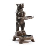 A BLACK FOREST LINDEN WOOD BEAR STICKSTAND BY THE RUEF BROTHERS OF BRIENZ, LATE 19TH / EARLY 20TH