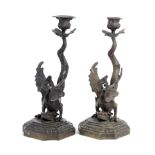 A NEAR PAIR OF FRENCH BRONZE CANDLESTICKS 19TH CENTURY each modelled as a winged dragon, its
