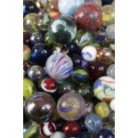 A COLLECTION OF GLASS MARBLES 19TH CENTURY AND LATER in various colours and sizes (A lot) 4.2cm