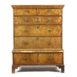 A WALNUT CHEST ON STAND EARLY 18TH CENTURY AND LATER with feather banding, the top with two short