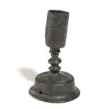 A MINIATURE OR DWARF BRONZE CANDLESTICK 15TH / 16TH CENTURY the tall, cylindrical nozzle on a