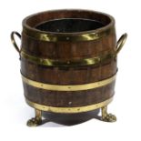 A COOPERED OAK LOG BIN EARLY 20TH CENTURY brass bound, with a pair of handles and a lift-out