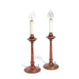 A PAIR OF RED JAPANNED TABLE LAMPS EARLY 20TH CENTURY each with an ogee nozzle and drip-tray on a