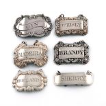 A collection of six antique silver wine labels, comprising: one by James Kirkby & Sons, Sheffield