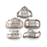 A collection of five George III silver wine labels, including: one of oval form, with a crested