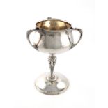 A Edwardian Art Nouveau silver cup, by Charles Edwards, London 1905, the bowl of circular tapering