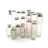 A collection of silver-mounted dressing table jars and bottles, various dates and makers, plain