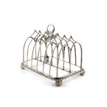 A George III silver seven-bar toast rack, by Cradock and Reid, London 1812, arched wire-work bars,