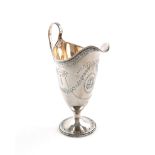 A George III silver cream jug, by John Denziloe, London 1785, of helmet form, bright cut