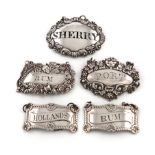 A small collection of five Scottish and Irish silver wine labels, comprising: a pair by John