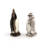Two novelty Scandinavian silver penguin pepper pots, modelled in standing positions, on round