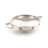 By A E Jones, an Arts & Craft silver two-handled dish, Birmingham 1932, circular form, spot-hammered