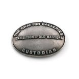 A silver arm badge, marked Silver, oval form, with raised lettering 'The Grafton Galleries