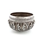 A Burmese metalware rice bowl, unmarked, circular form, embossed with figural scenes within