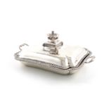 A George III silver entree dish and cover, by Thomas Heming, London 1765, shaped rectangular form,