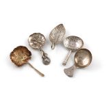 A collection of five antique silver caddy spoons, by various makers and dates, comprising: a