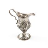 A George III silver cream jug, by John Lambe, London 1783, baluster form, embossed foliate and
