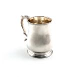 A George II silver mug, by Gabriel Sleath, London 1747, baluster form, leaf capped scroll handle, on