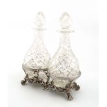 A William IV silver decanter/oil and vinegar frame with later glass decanters, by Robert Garrard,