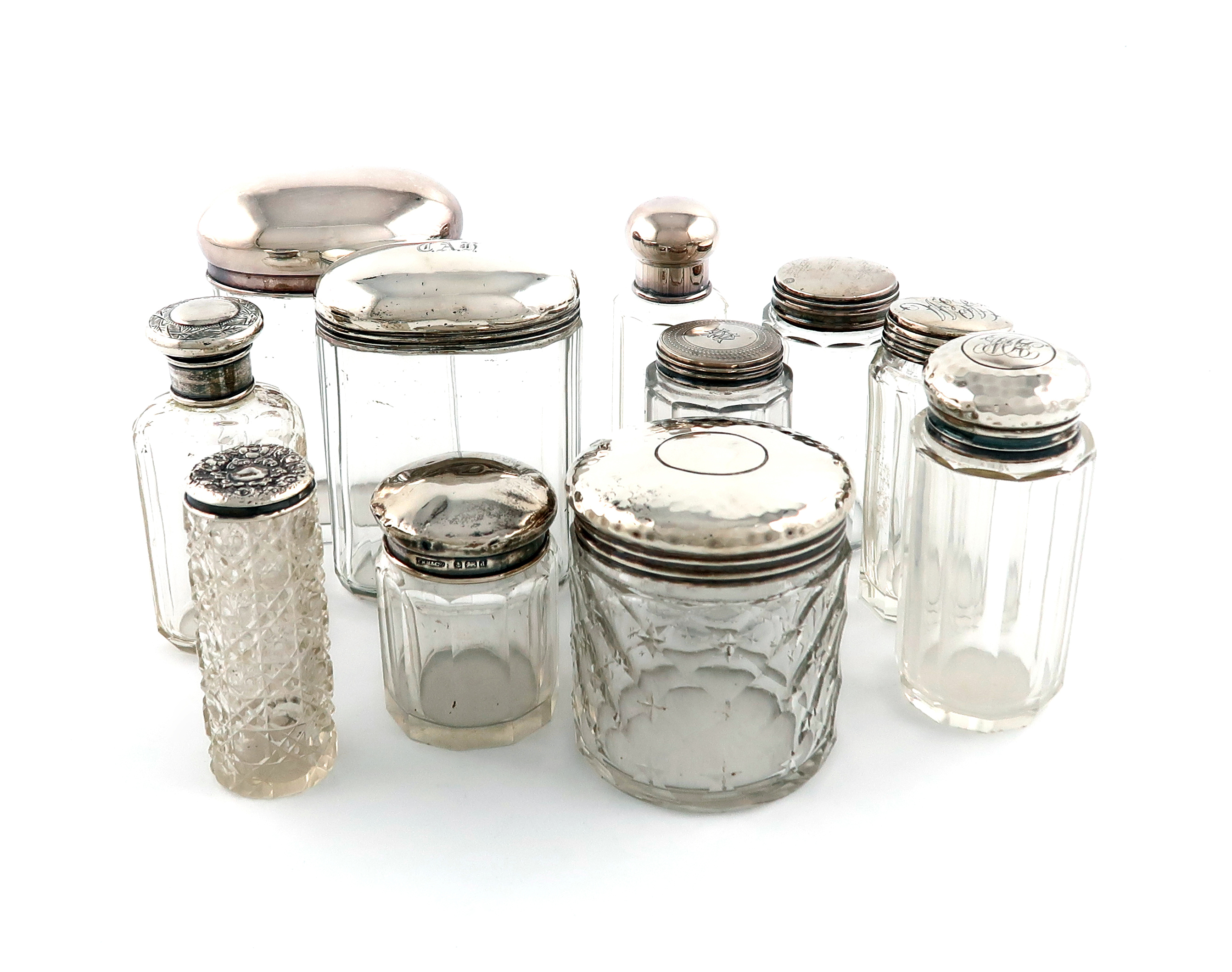 A collection of nine silver-mounted and dressing table jars, various dates and makers, various