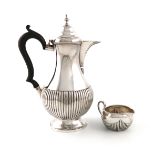 A Victorian silver hot water pot and cream jug, the hot water pot by Mappin & Webb, Sheffield