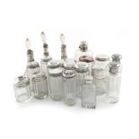 A collection of silver-mounted glass jars and scent bottles, various dates and makers, comprising: