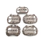 A collection of five antique silver labels, of rectangular form, shell, vine, gadrooned borders,