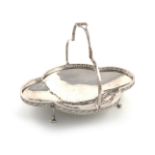 By A E Jones, an Arts and Crafts silver swing-handled basket, Birmingham 1923, shaped oval form,