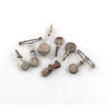 A collection of seven silver napkin clips, various dates and makers, including two with pin bars,