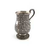 An Indian silver mug, unmarked, probably Cutch, baluster form, chased with animals and scrolls on