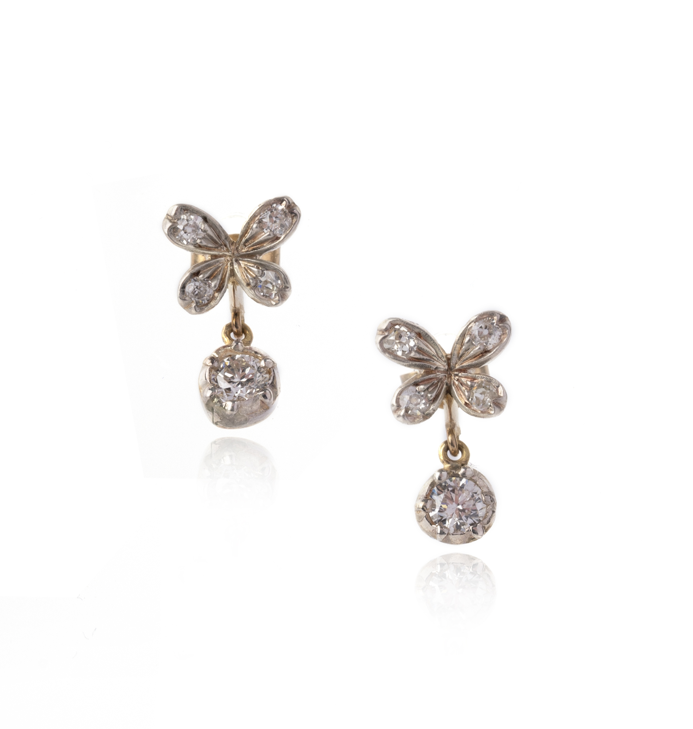 A pair of diamond drop earrings, the quatrefoil flowerhead tops set with old cushion-shaped